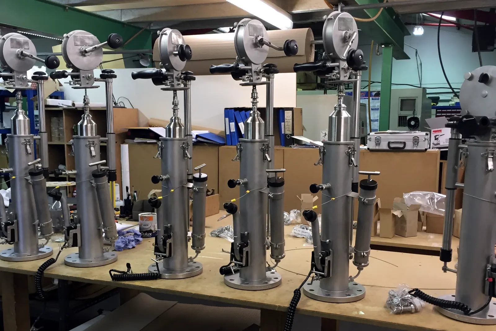 Six MK 12 closed sampling winders on a workshop bench, being prepared for dispatch